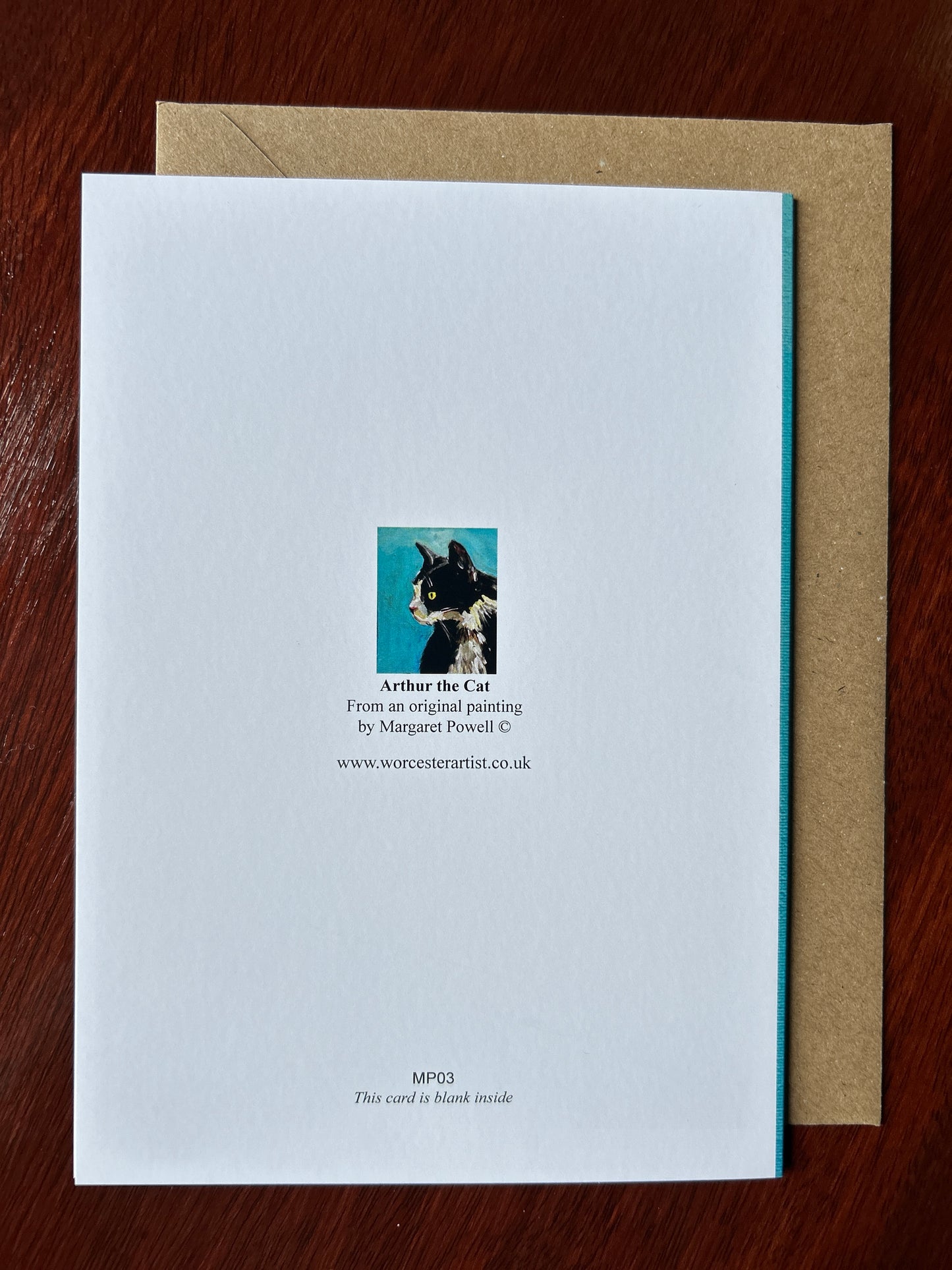Rear of greetings card predominantly white with small picture of a black and white cat in the centre of the card with the words Arthur the Cat from an original painting by Margaret Powell www.worcesterartist.co.uk