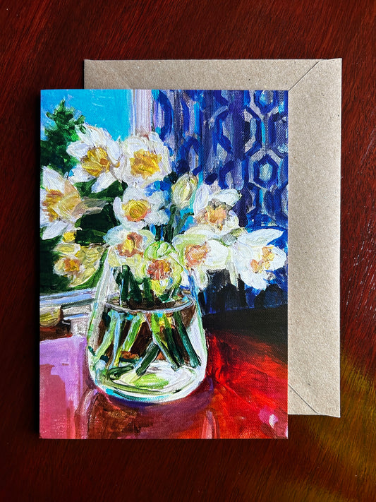 Greetings card of daffodils in a glass vase. Displayed with brown envelope.