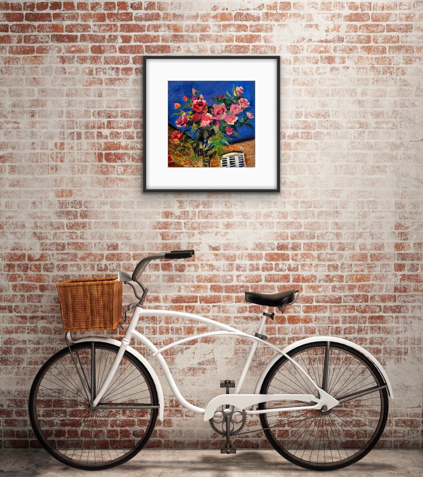 Print of Original fine art painting by Worcester artist Margaret Powell entitled Debbie's Roses displayed against a brick wall with old fashioned white bicycle with wicker basket below