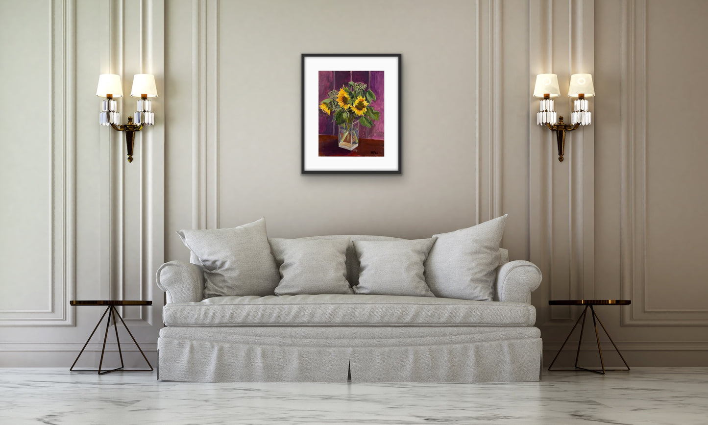 Print of Original painting by Margaret Powell Worcestershire artist of Farm Sunflowers and Sedum in a Clear Vase. Displayed in a black frame with white mount against a white wall with furniture in front.
