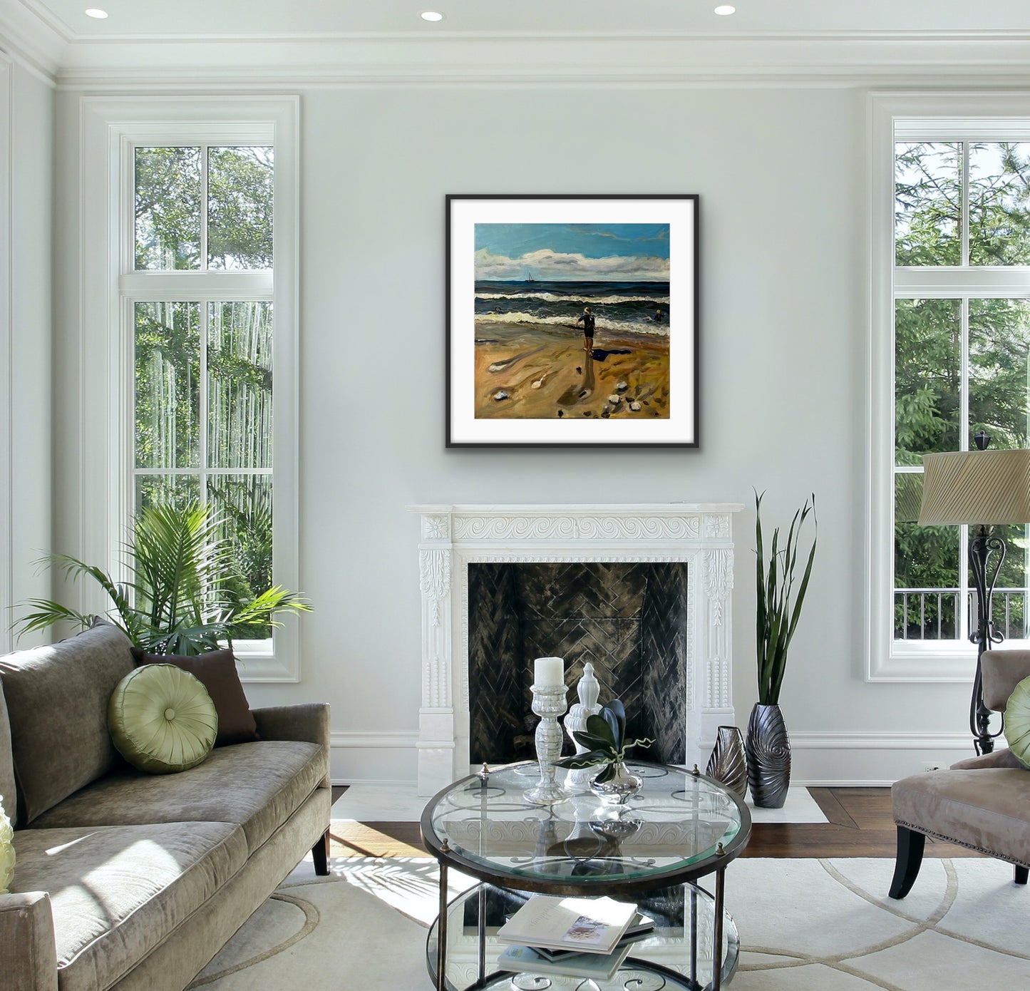 Print of original painting of Girl on Caswell Bay Beach by Margaret Powell. Displayed in black frame with white mount on white wall with furniture in front.