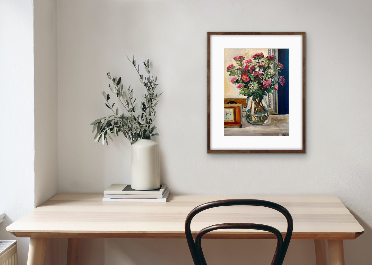 Framed print of Asters in the Sitting Room fine art painting. Displayed on a white wall with table and chair in front.