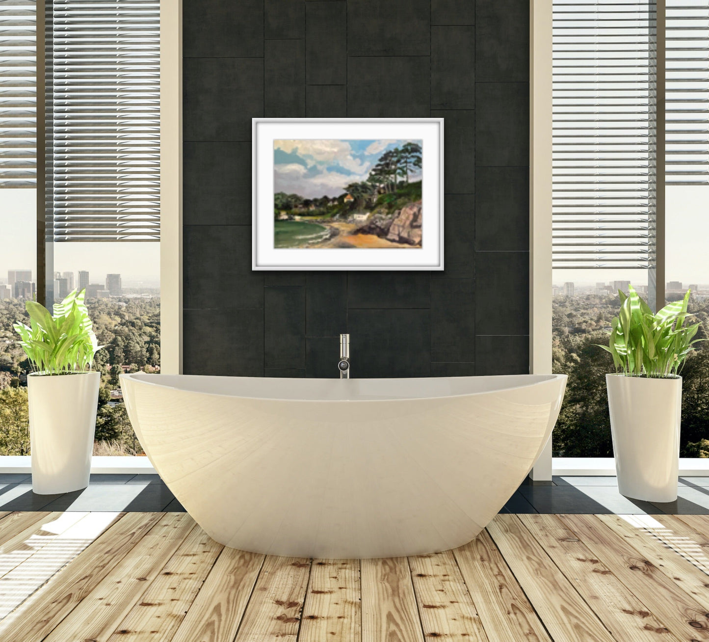 Painting of Caswell Bay in the Gower, Wales with white clouds in a blue sky and rocks and sea in foreground with trees and houses on the headland. Displayed in a frame on a dark grey wall with a white bed in the foreground.