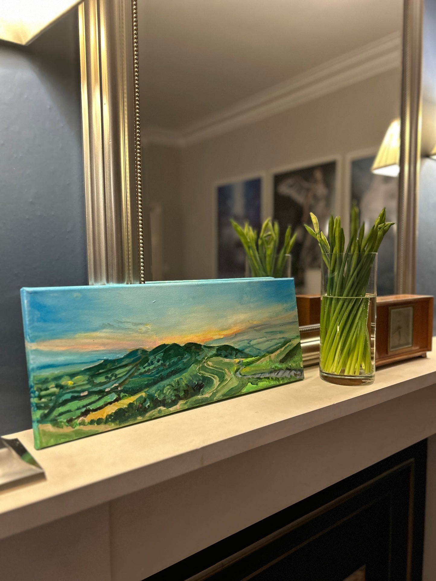 Original painting of Dawn at the Malvern Hills by Worcestershire Artist Margaret Powell displayed on a mantel piece in front of mirror