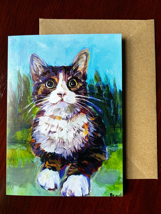 Greetings card of Bella the Kitten painted with trees and grass in background.